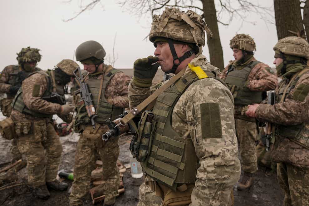 Ukrainian servicemen check their equipment during an exercise (Vadim Ghirda/AP)