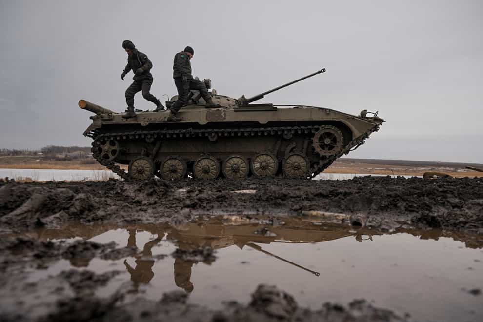 Ukrainian servicemen walk on an armoured fighting vehicle during an exercise in a Joint Forces Operation controlled area in the Donetsk region, eastern Ukraine (Vadim Ghirda/AP)