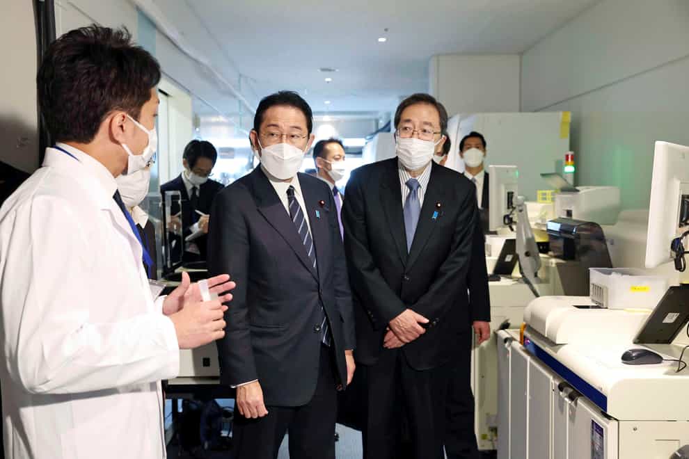 Japanese Prime Minister Fumio Kishida at a quarantine area at the Haneda international airport in Tokyo (Kyodo via AP)