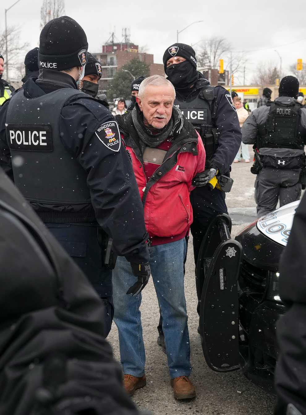 A protester is arrested as police remove truck drivers and supporters at the Ambassador Bridge linking Detroit and Windsor (Nathan Denette/The Canadian Press via AP)