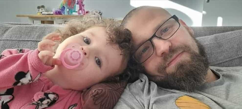 Mark Cummins, 37, with his two-year-old daughter Shannon, whom he resuscitated with the help of an emergency phone operator after she stopped breathing (Mark Cummins/PA)