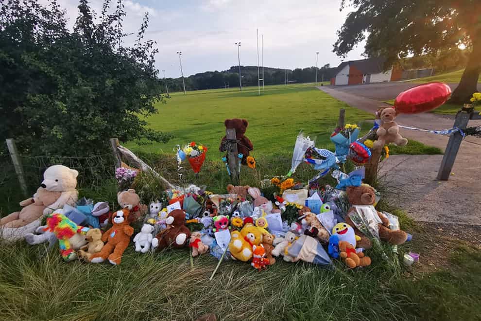 Tributes left near Pandy Park in Sarn, Bridgend, close to where the body of Logan Mwangi was discovered (PA)