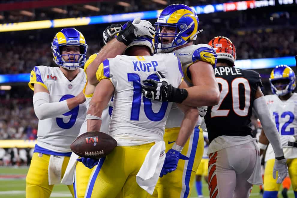 Los Angeles Rams wide receiver Cooper Kupp (10) is congratulated by teammates after scoring a touchdown against the Cincinnati Bengals during the second half of the NFL Super Bowl (AP Photo/Marcio Jose Sanchez)