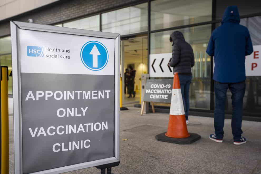 People queuing at a Covid-19 vaccination centre (Liam McBurney/PA)