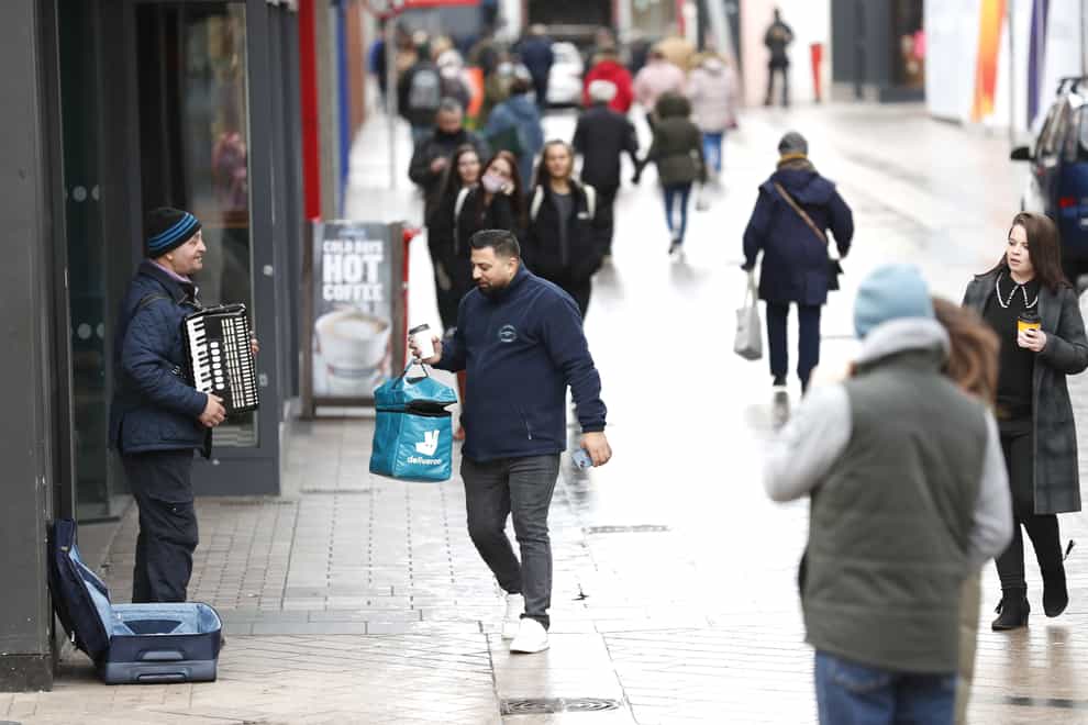 Shoppers go about their business in Belfast city centre (PA)