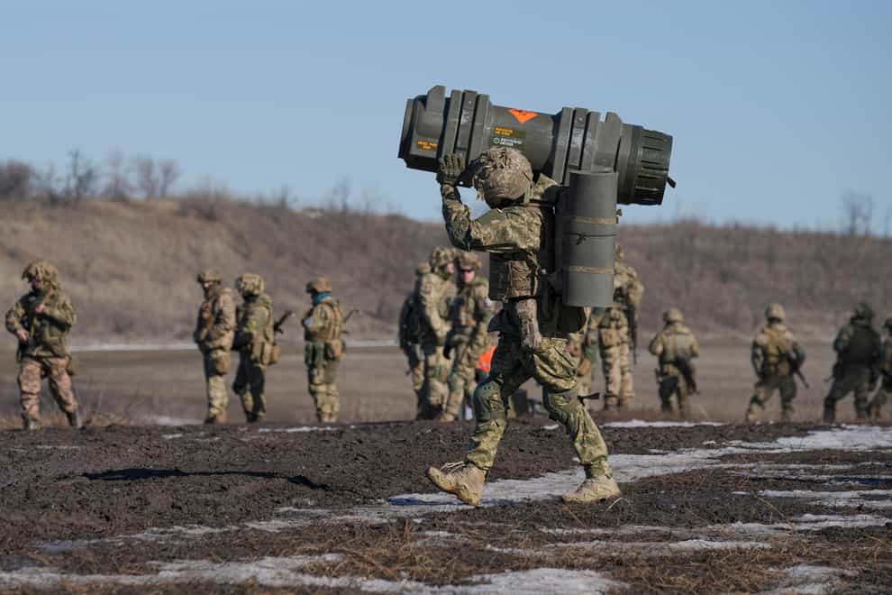 A Ukrainian serviceman carries an NLAW anti-tank weapon during an exercise in the Joint Forces Operation, in the Donetsk region, eastern Ukraine (Vadim Ghirda/AP)