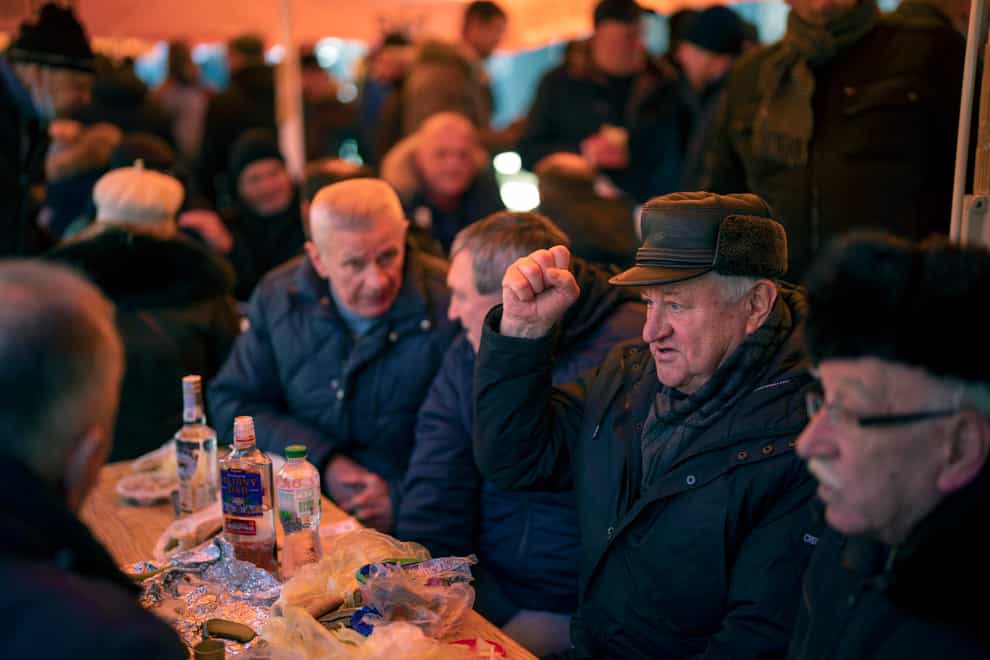 People gather and eat in an open air coffee shop in Kyiv, Ukraine, on Tuesday. (Emilio Morenatti/AP/Press Association Images)
