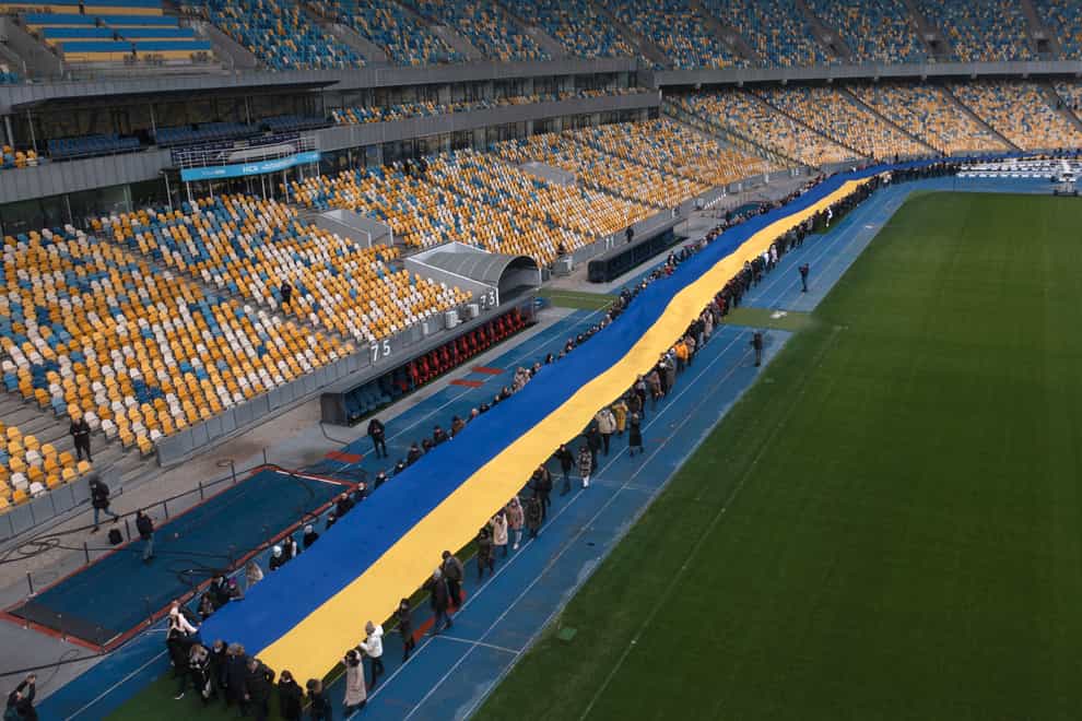 A 200m-long Ukrainian flag is unfolded at the Olympiyskiy stadium in Kyiv, Ukraine (Efrem Lukatsky/AP)