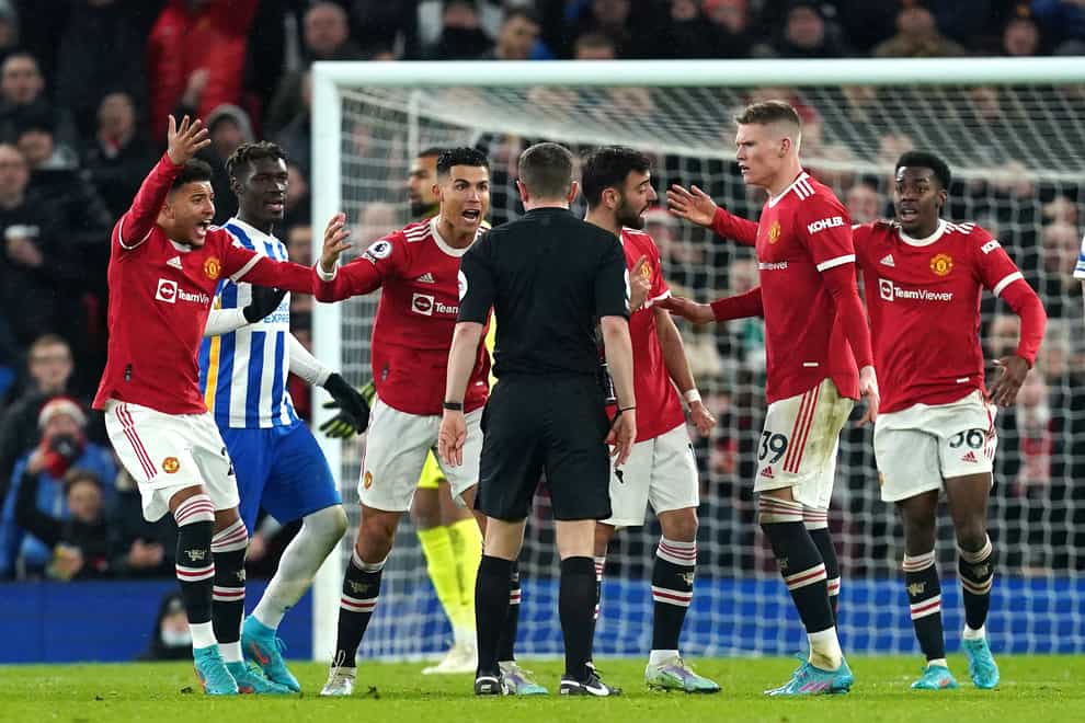 Manchester United players fume at referee Peter Bankes (Martin Rickett/PA)