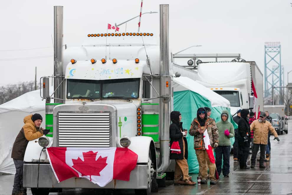 Truckers and supporters block the access leading from the Ambassador Bridge (Nathan Denette/The Canadian Press via AP)
