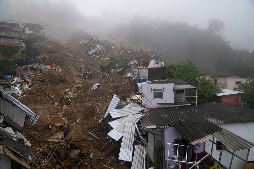 Rescue workers and residents search for survivors after mudslides in Petropolis, Brazil (Silvia Izquierdo/AP)