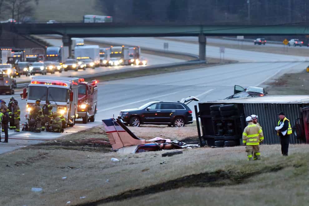 Emergency personnel at the scene where a twin-engine Beechcraft Barron plane crashed into a tractor-trailer on Interstate 85 South in Lexington, North Caroline (Walt Unks/The Winston-Salem Journal/AP)