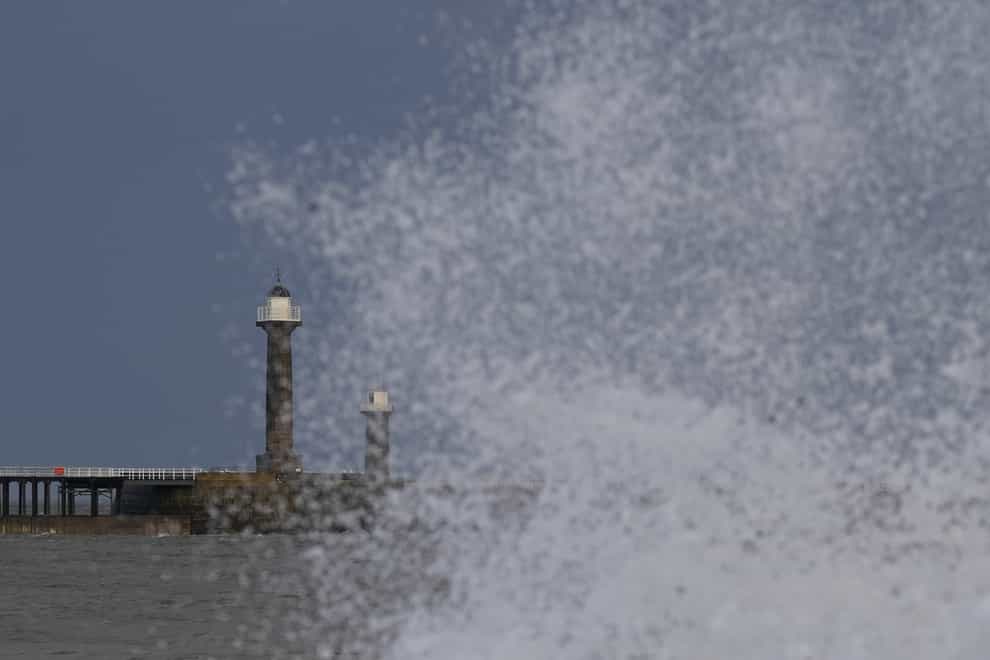 Waves hit the sea wall at Whitby, Yorkshire (Danny Lawson/PA)