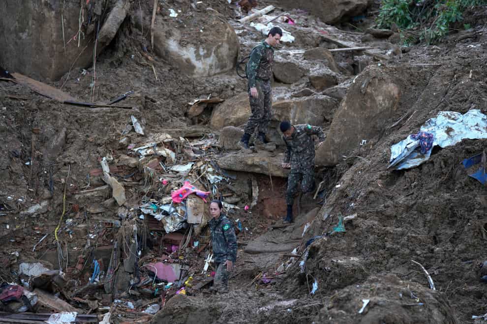 Soldiers look for survivors on the second day of rescue efforts (Silvia Izquierdo/AP)