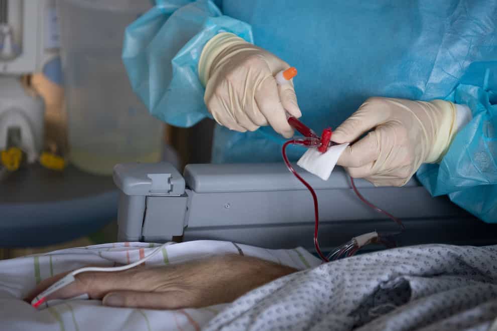 A nurses takes care for a patient with severe Covid-19 in Fulda, Germany (dpa via AP)