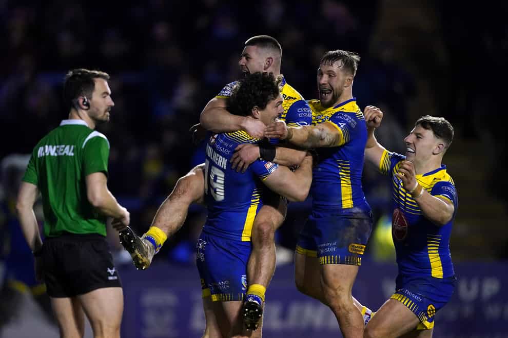 Warrington celebrate Rob Mulhern’s try during their 34-0 Super League win against Castleford (Martin Rickett/PA)