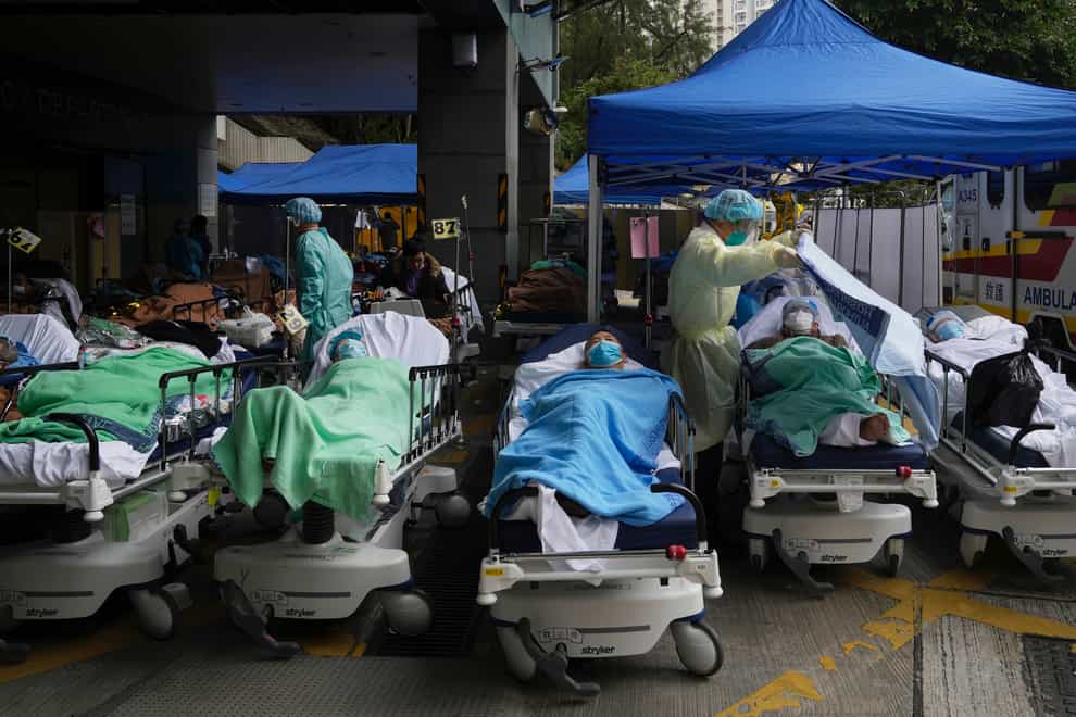 Patients lie on hospital beds as they wait at a temporary makeshift treatment area outside Caritas Medical Centre in Hong Kong (AP)