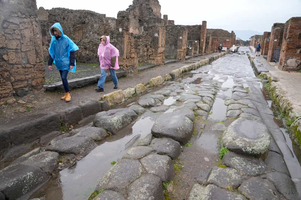 Tourists walk inside the Pompeii archaeological site in southern Italy (Gregorio Borgia/AP)