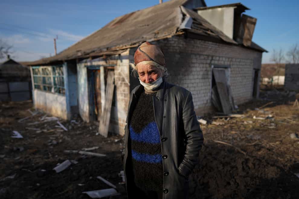 Tetyana Tomenko, a local resident, cries standing in front of her damaged house after alleged shelling by separatist forces in Novognativka, eastern Ukraine (Evgeniy Maloletka/AP)
