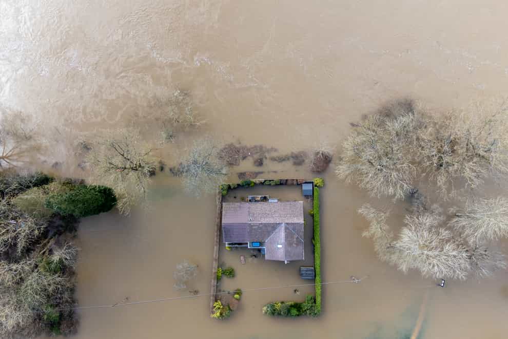 A property surrounded by floodwater after the River Severn burst its banks (PA)