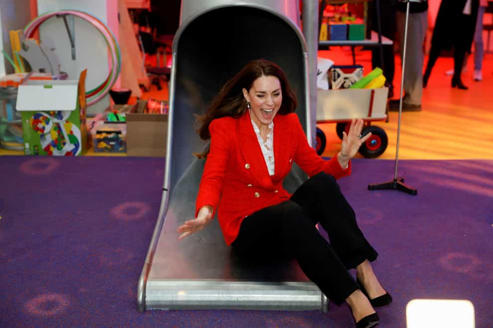 The Duchess of Cambridge laughs as she comes down a slide during a visit to the Lego Foundation PlayLab in Copenhagen (John Sibley/PA)