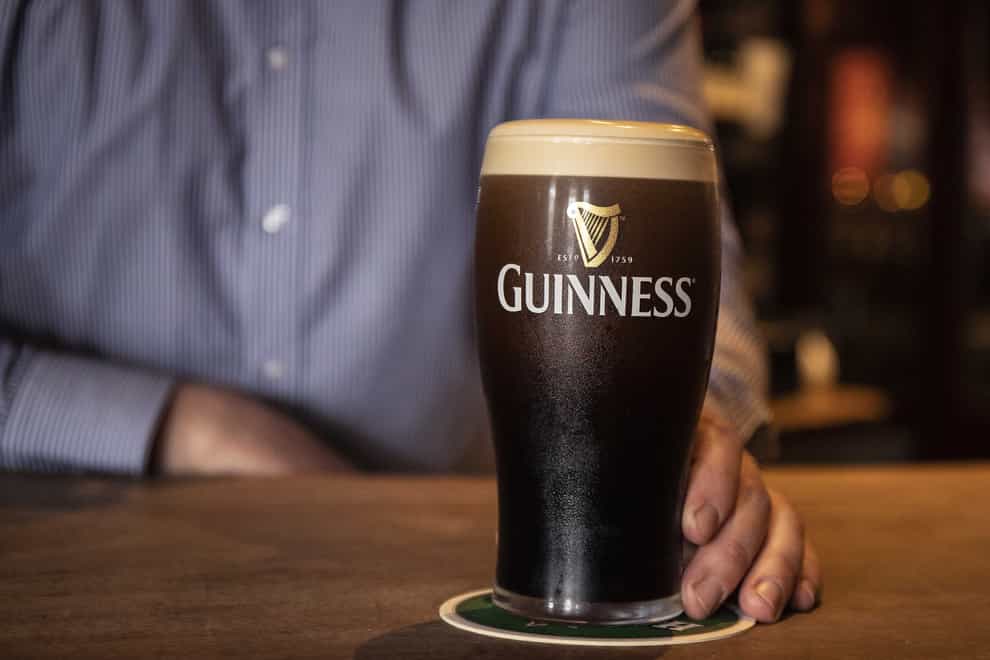 Darren Cusack, barman at Mulligan’s in Poolbeg Street, Dublin, pours a pint of Guinness as indoor dining in pubs and restaurants have reopened across Ireland, marking a significant step for the hospitality sector. Picture date: Monday July 26, 2021.
