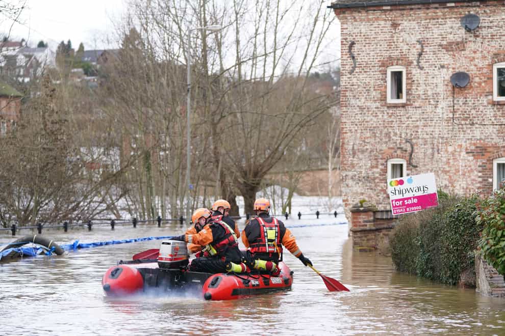 A fire and rescue team in floodwater in Bewdley, Worcestershire (Joe Giddens/PA)