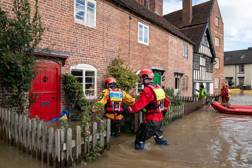 Search and rescue teams check on residents in Bewdley, Worcestershire, where floodwater from the River Severn has breached the town’s flood defences following high rainfall from Storm Franklin (Joe Giddens/PA)
