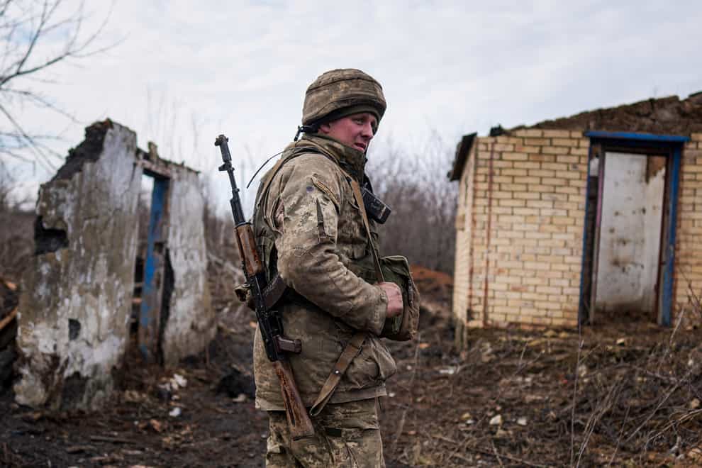 A Ukrainian serviceman stands at his position at the line of separation (Evgeny Maloletka/AP)