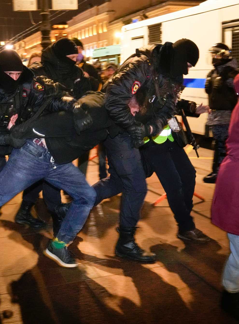 Police officers detain a demonstrator in St Petersburg (Dmitri Lovetsky/AP)