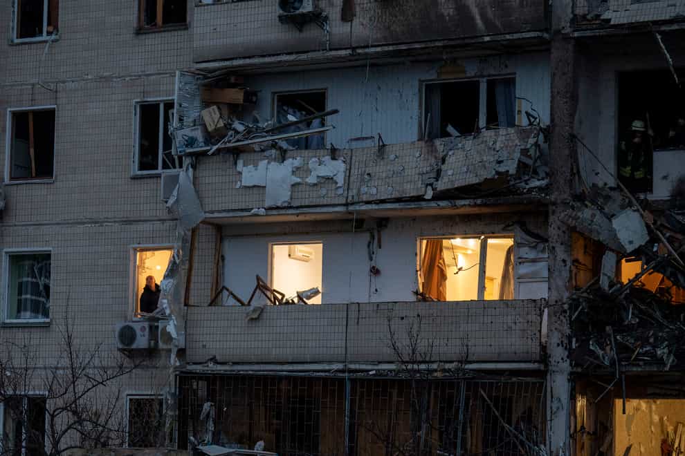 A man inspects the damage following a rocket attack in Kyiv (Emilio Morenatti/AP)