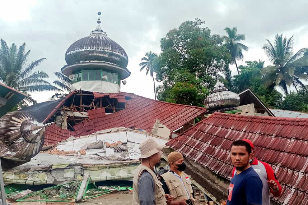 People inspect a damaged mosque following an earthquake in Pasaman, West Sumatra, Indonesia, Friday, Feb. 25, 2022. The strong and shallow earthquake hit off the coast of Indonesia’s Sumatra island on Friday, panicking people in Sumatra island and neighboring Malaysia and Singapore. (AP Photo/Marsulai)