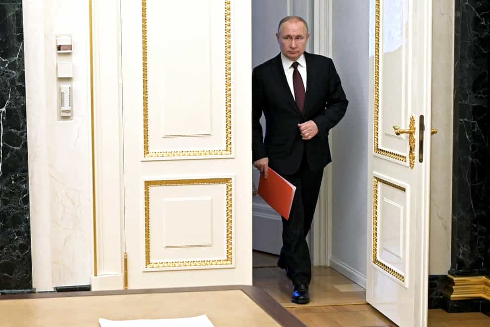 Russian President Vladimir Putin enters a hall to chair a Security Council meeting in Moscow, Russia, Friday, Feb. 25, 2022. (Alexei Nikolsky, Sputnik, Kremlin Pool Photo via AP)