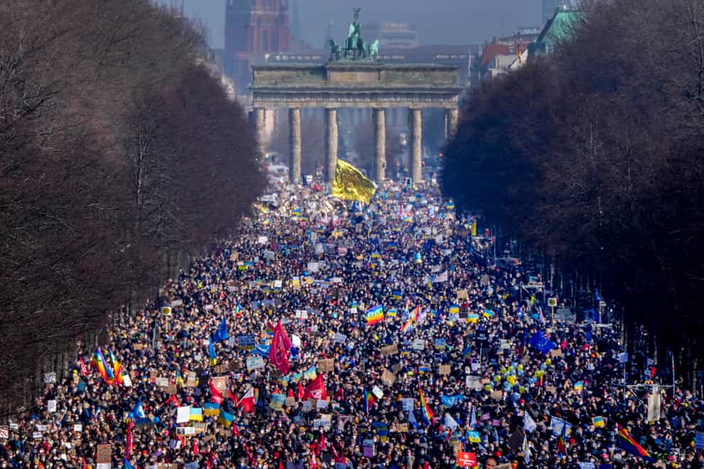 People walk down the boulevard Strasse des 17. Juni ahead of a rally against Russia’s invasion of Ukraine in Berlin, Germany (Markus Schreiber/AP)