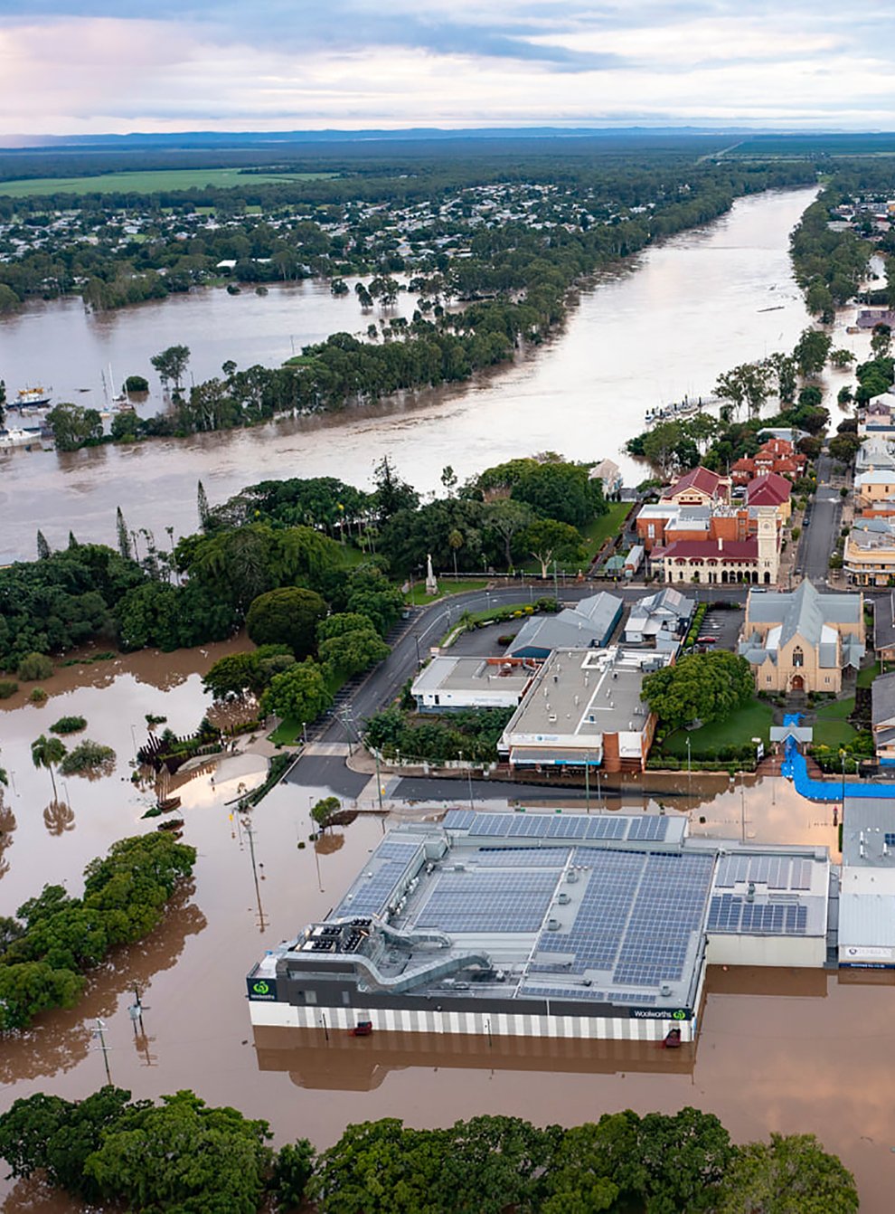 Water floods streets and houses in Maryborough, Australia (Queensland Fire and Emergency Services via AP)