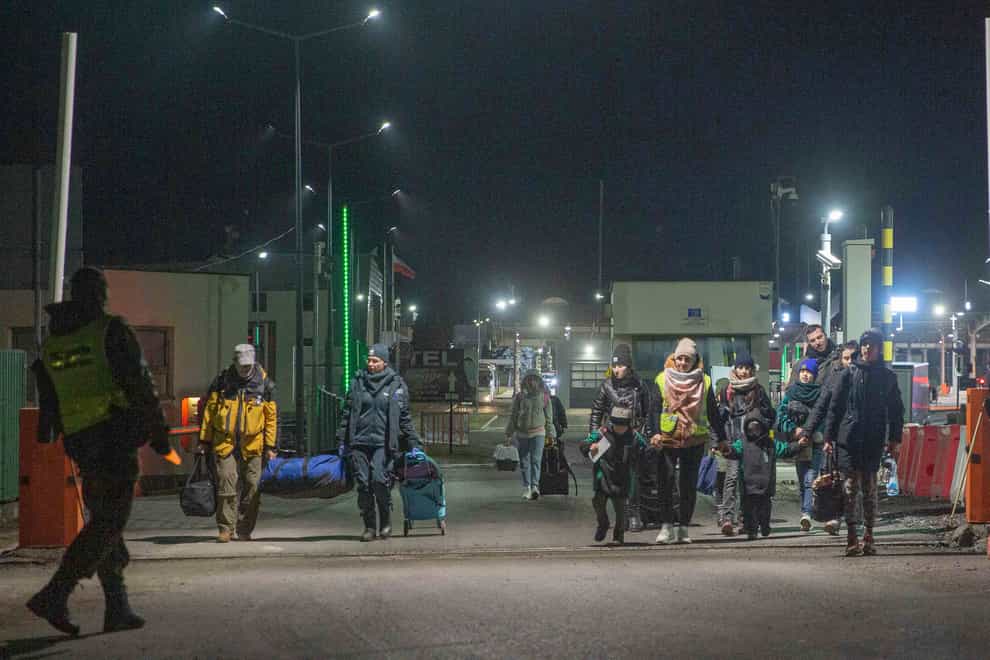 Refugees fleeing conflict in Ukraine arrive at the Medyka border crossing in Poland (Visar Kryeziu/AP)