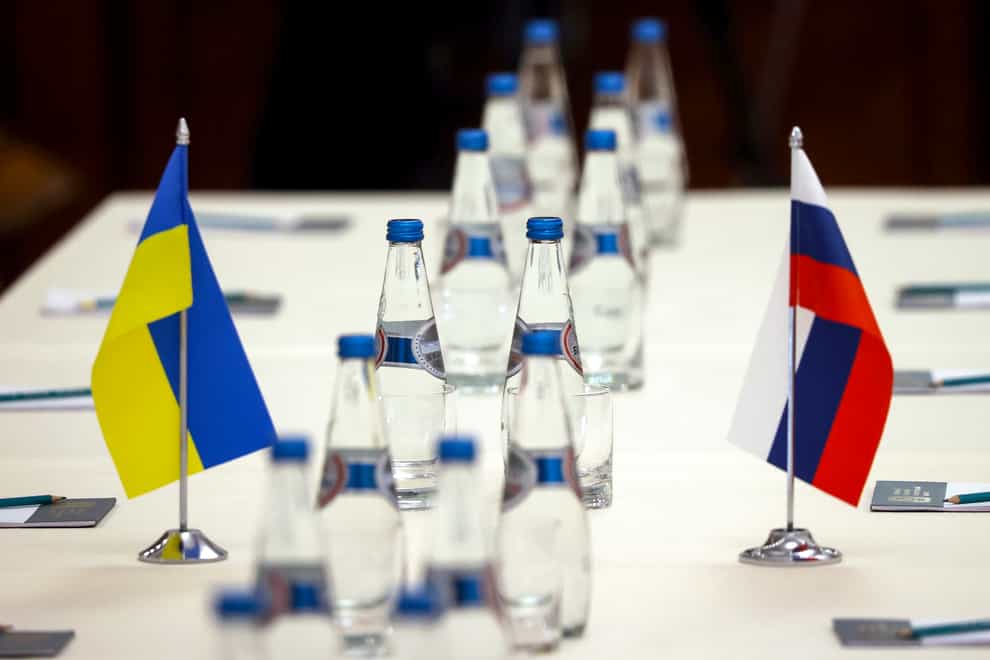 Ukrainian and Russian national flags are placed on the table ahead of peace talks between Russian and Ukrainian delegations (Seregi Kholodilin/AP)