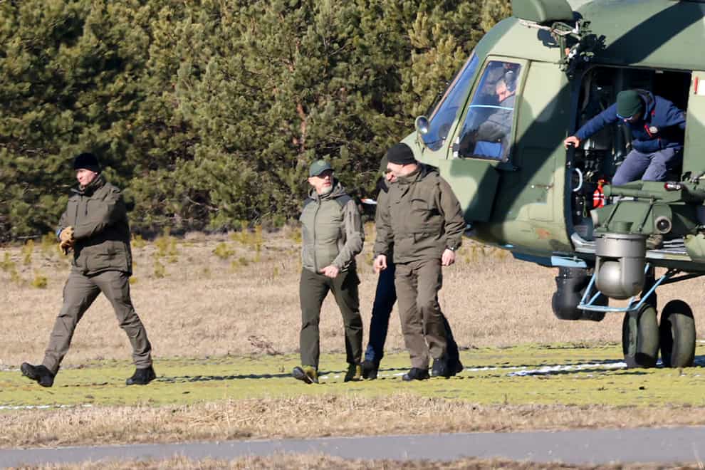 The Ukrainian delegation leaves a Belarusian military helicopter upon their landing in Gomel region, Belarus (Sergei Kholodolin/AP)