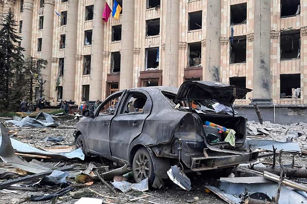 A burnt car is seen in front of a damaged City Hall building, in Kharkiv (Ukrainian Emergency Service/AP)