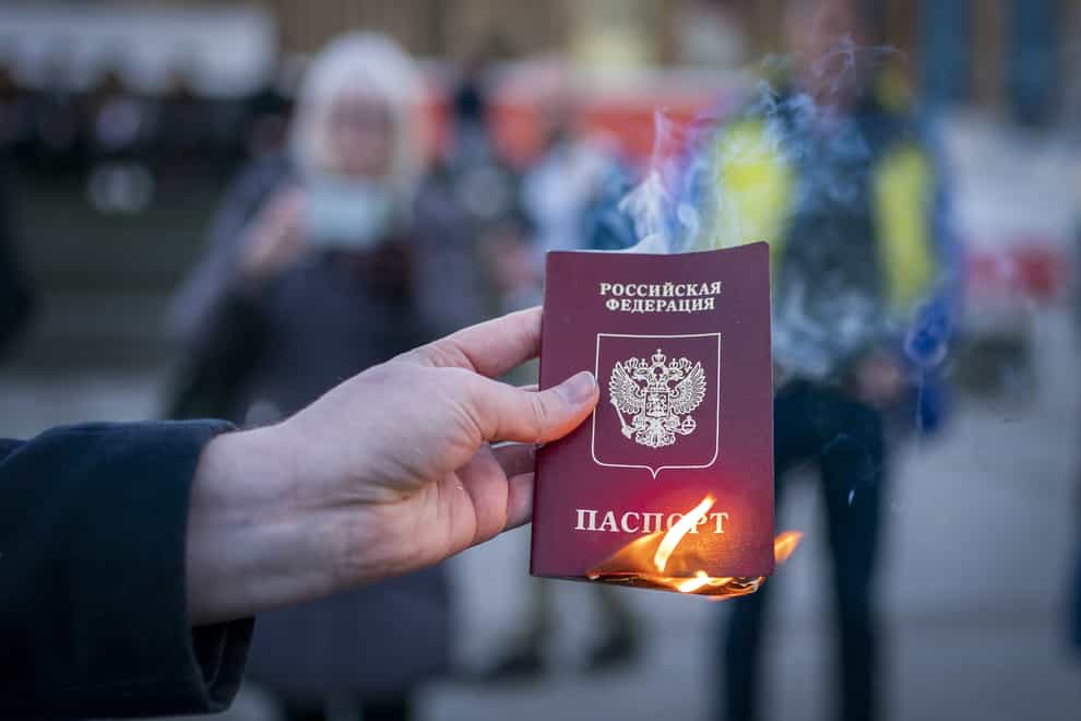 Anna Jakubova sets fire to her Russian passport during the Standing In Solidarity With Ukraine vigil on The Mound, Edinburgh, following the Russian invasion of Ukraine (Jane Barlow/PA)