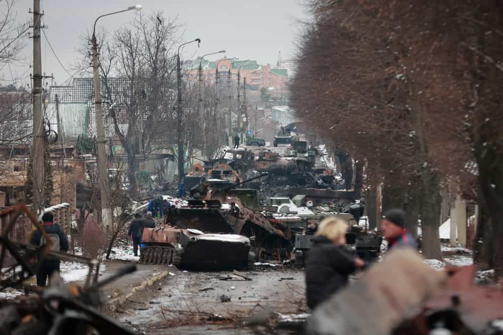 The gutted remains of Russian military vehicles on a road in Bucha, close to the capital Kyiv (Serhii Nuzhnenko/AP)