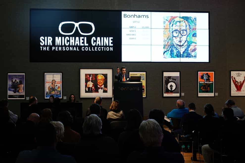 A portrait of Sir Michael Caine by artist John Bratby R.A. sells for £25,000 during the Sir Michael Caine collection sale at Bonhams in London. The sale contains a selection of items reflecting the breadth of Sir Michael’s career, ranging from movie posters, furniture including his desk, works of art and fine art (Aaron Chown/PA)