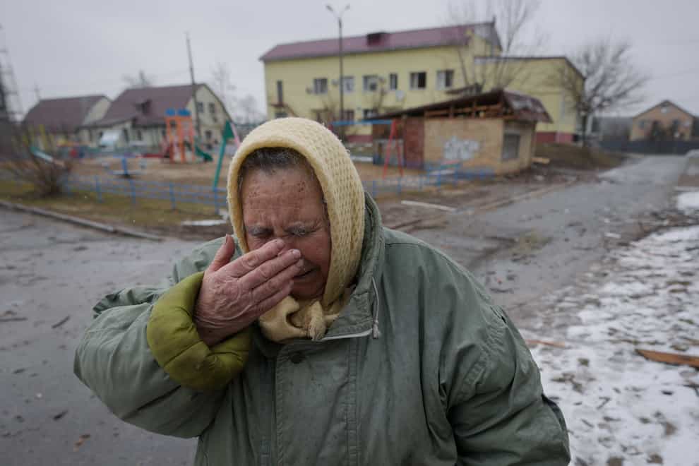 A woman cries outside houses damaged by a Russian air strike, according to locals, in Gorenka, outside the capital Kyiv, Ukraine (Vadim Ghirda/AP)