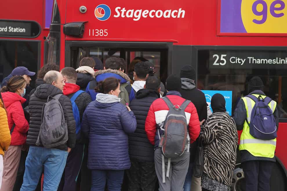 Commuters board buses outside Stratford tube station in London (Stefan Rousseau/PA)