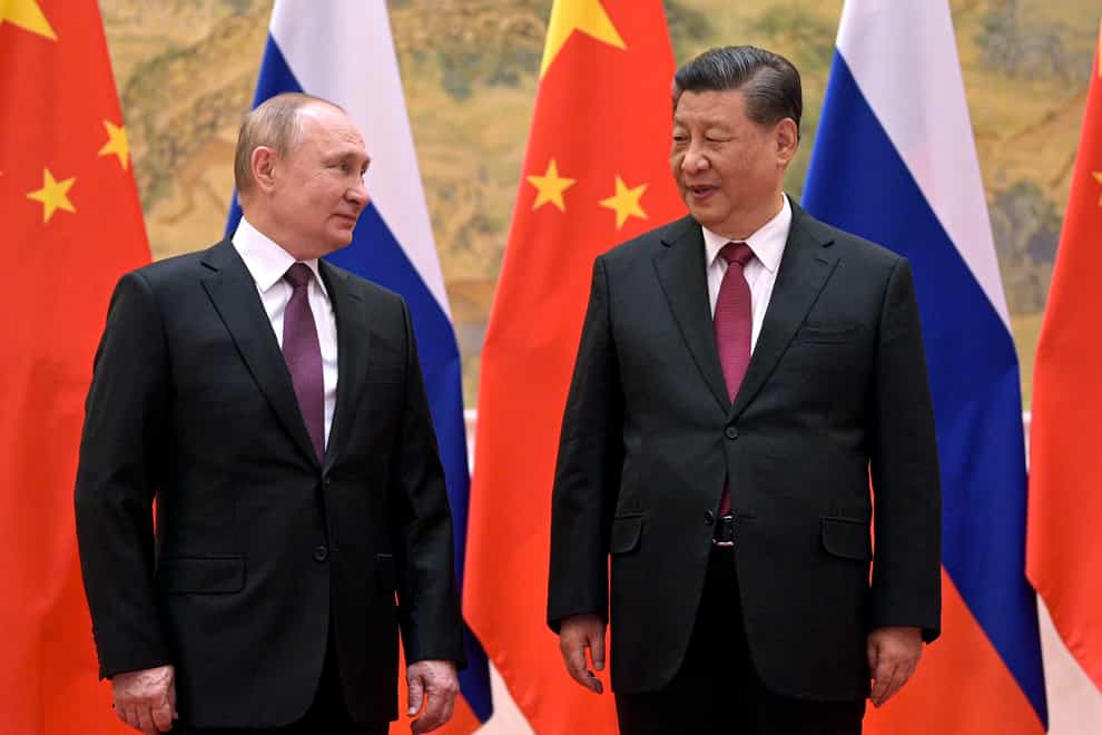 Chinese President Xi Jinping, right, and Russian President Vladimir Putin talk to each other during their meeting in Beijing on February 4 2022 (Alexei Druzhinin, Sputnik, Kremlin Pool Photo via AP, File)