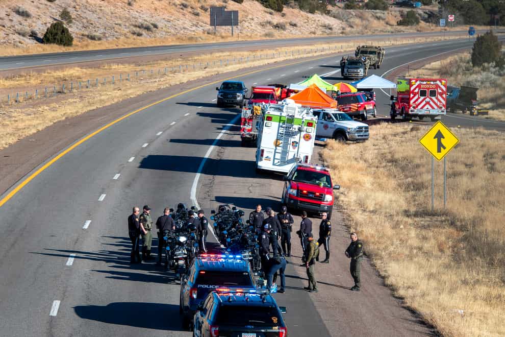 Police gather along Interstate 25 as several agencies take part in a search for a suspect who was involved in a kidnapping and high speed chase that resulted in a Santa Fe Police Officer being killed (Eddie Moore/The Albuquerque Journal/PA)