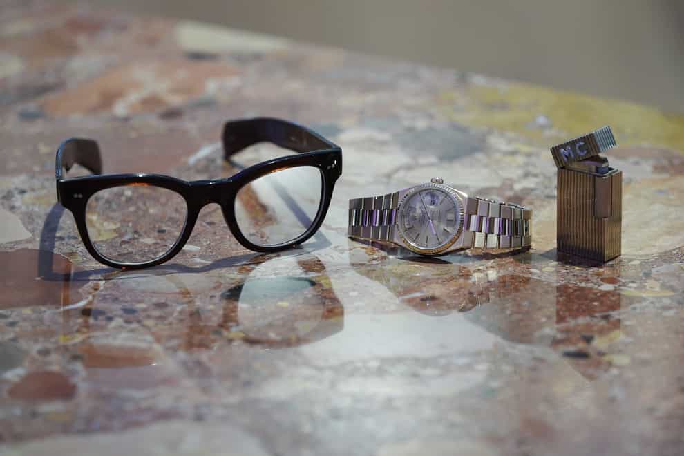 The auction included a pair of glasses, an £18,000 gold Rolex Oysterquartz watch and a diamond-set lighter (Yui Mok/PA)