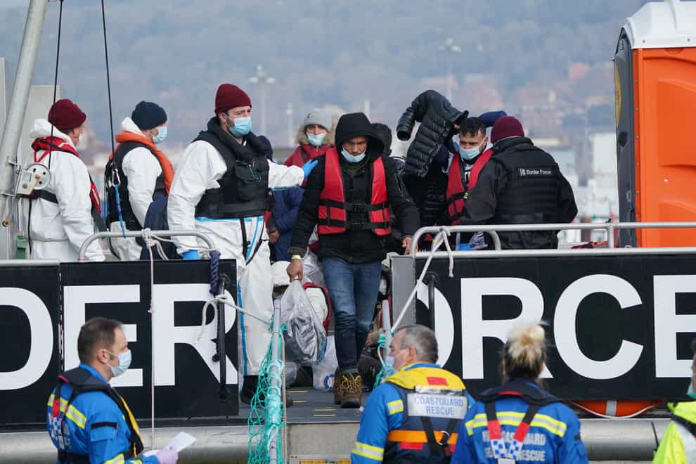 A group of people thought to be migrants are brought in to Dover, Kent, by Border Force officers following a small boat incident in the Channel. Picture date: Thursday March 3, 2022. (Gareth Fuller/PA)