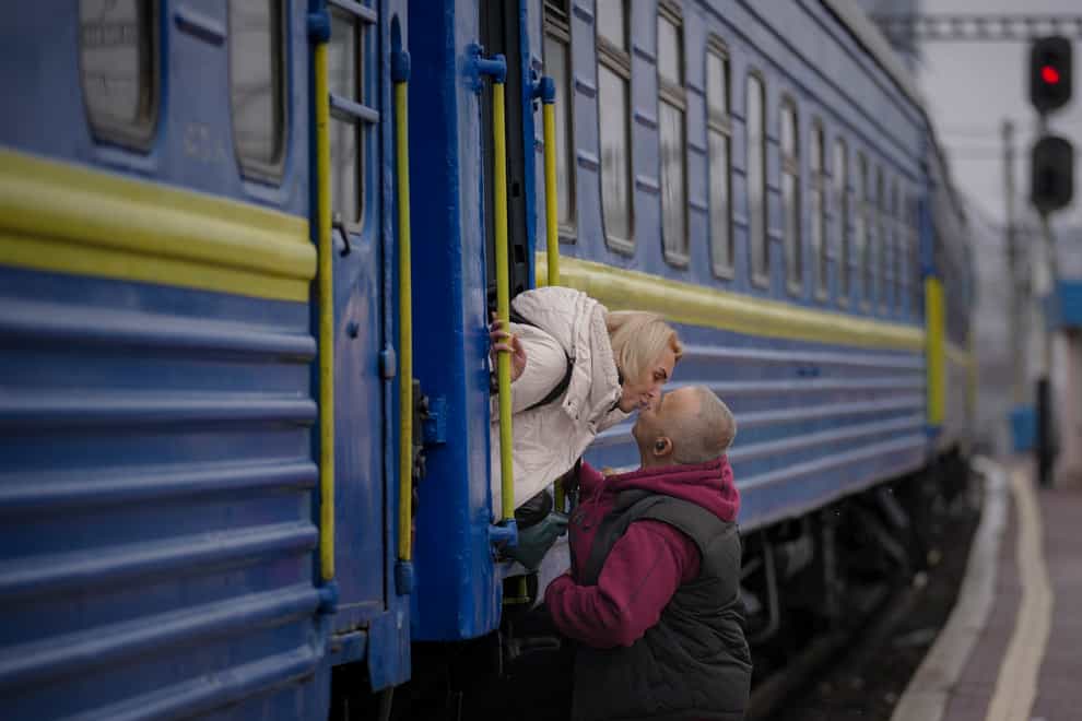 A woman kisses a man good bye after boarding a Lviv bound train, in Kyiv, Ukraine (Vadim Ghirda/AP)