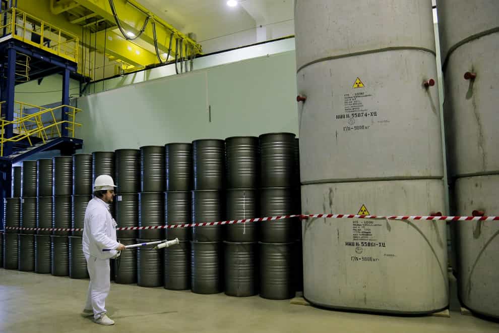 A worker checks the radiation level on barrels in a storage of nuclear waste taken from the fourth unit destroyed by explosion at the Chernobyl nuclear power plant, Chernobyl, Ukraine (Efrem Lukatsky/AP)